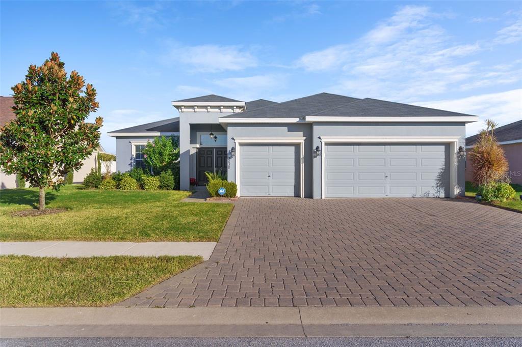 a front view of a house with a yard and garage