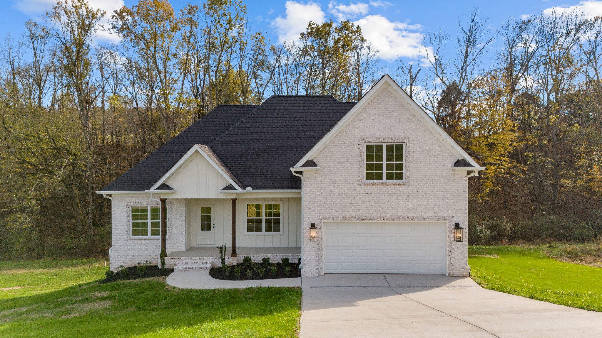 a front view of house with yard and green space