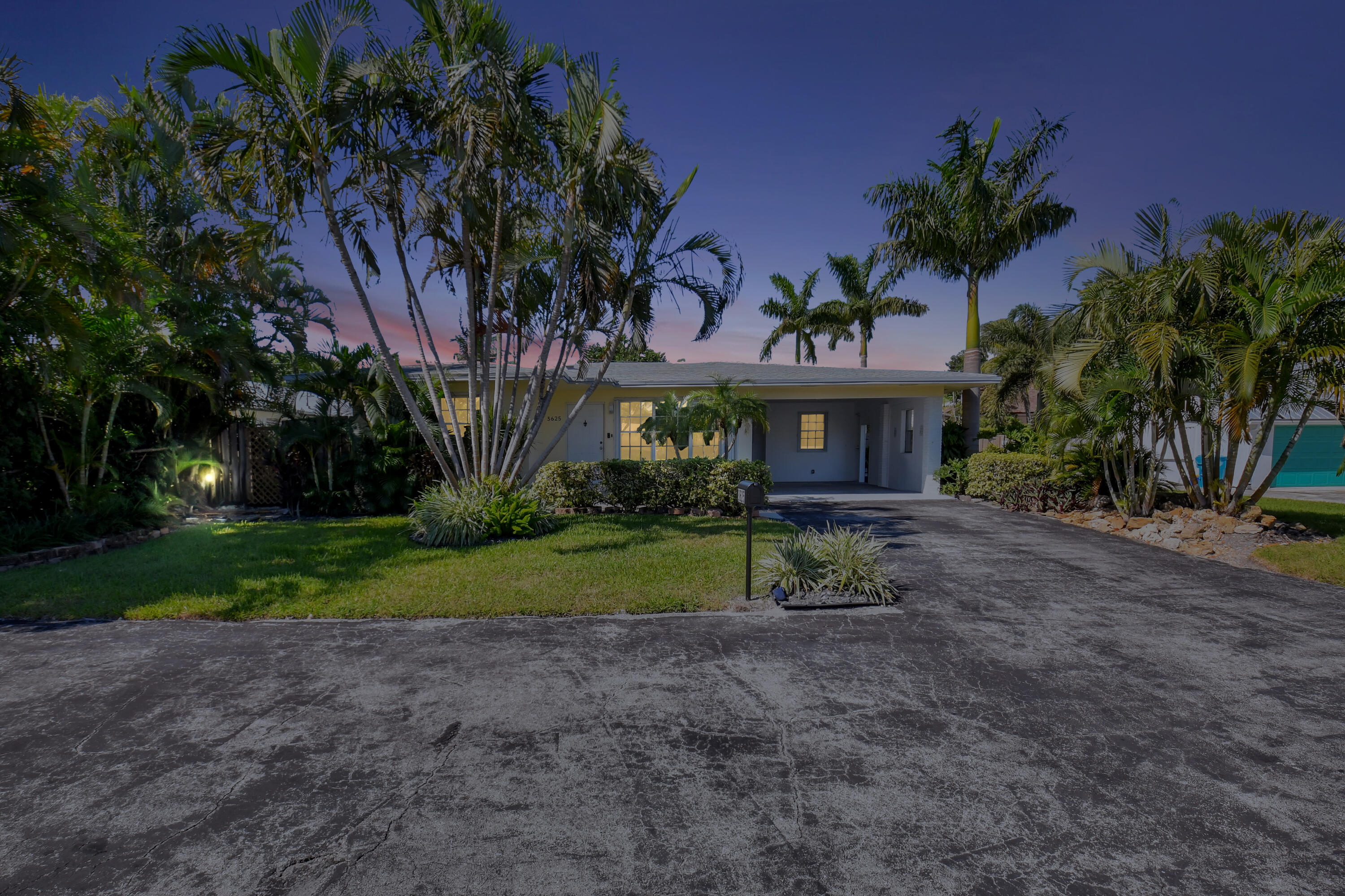 a view of a house with a yard and garage