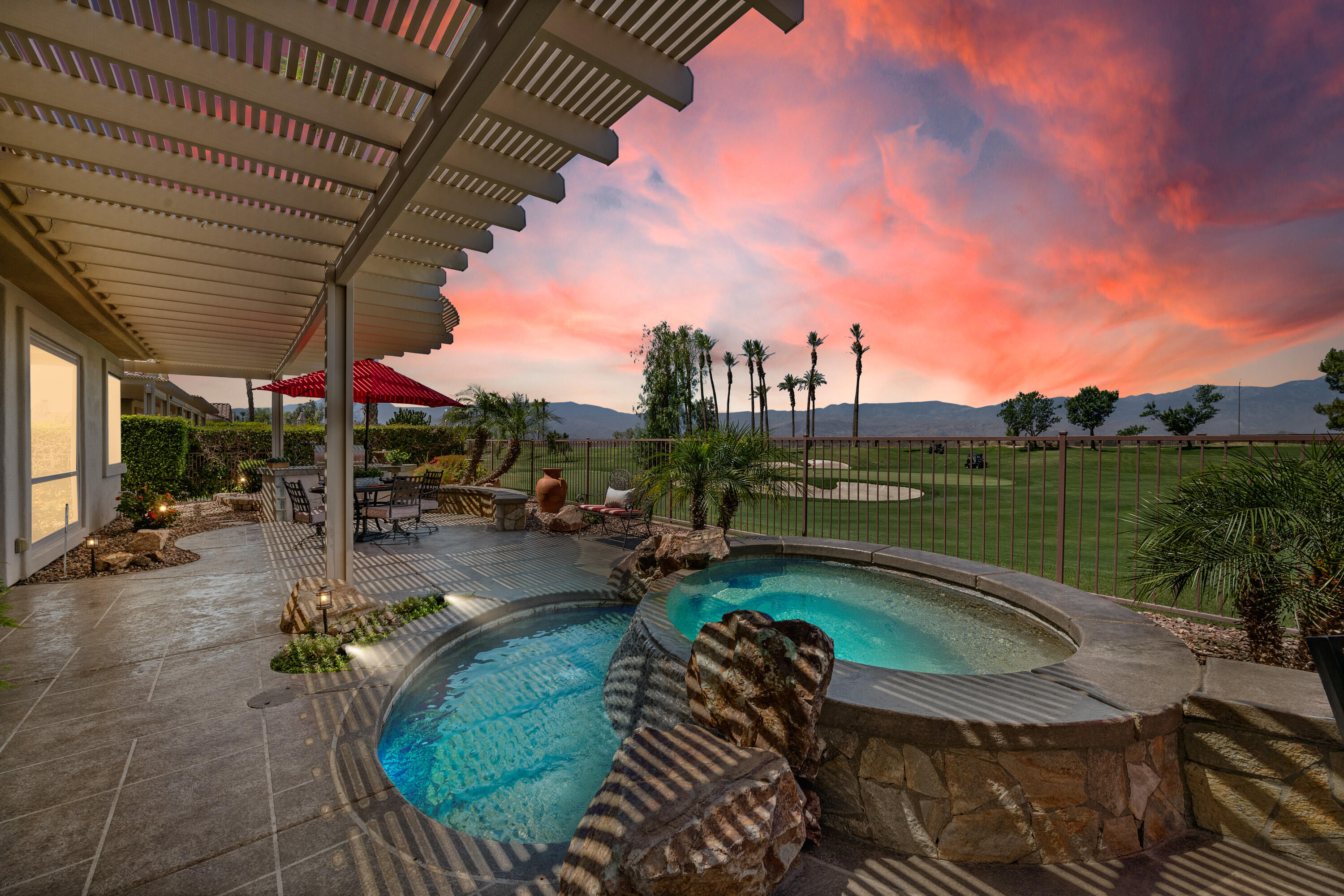 a view of a swimming pool and lounge chairs in patio