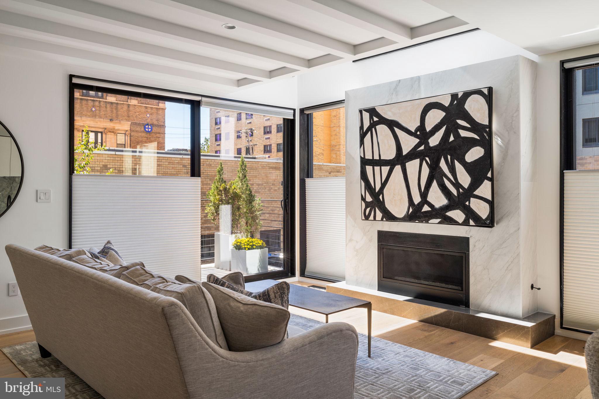 a living room with furniture a fireplace and a window