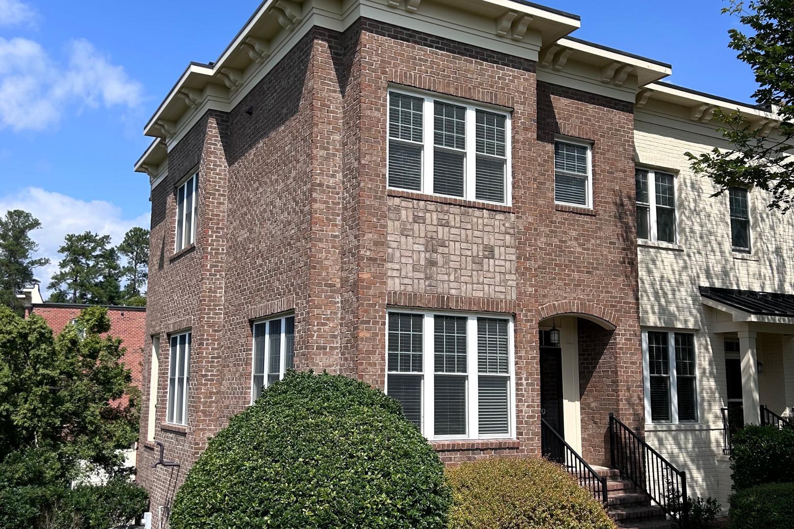 a front view of a house with a garden