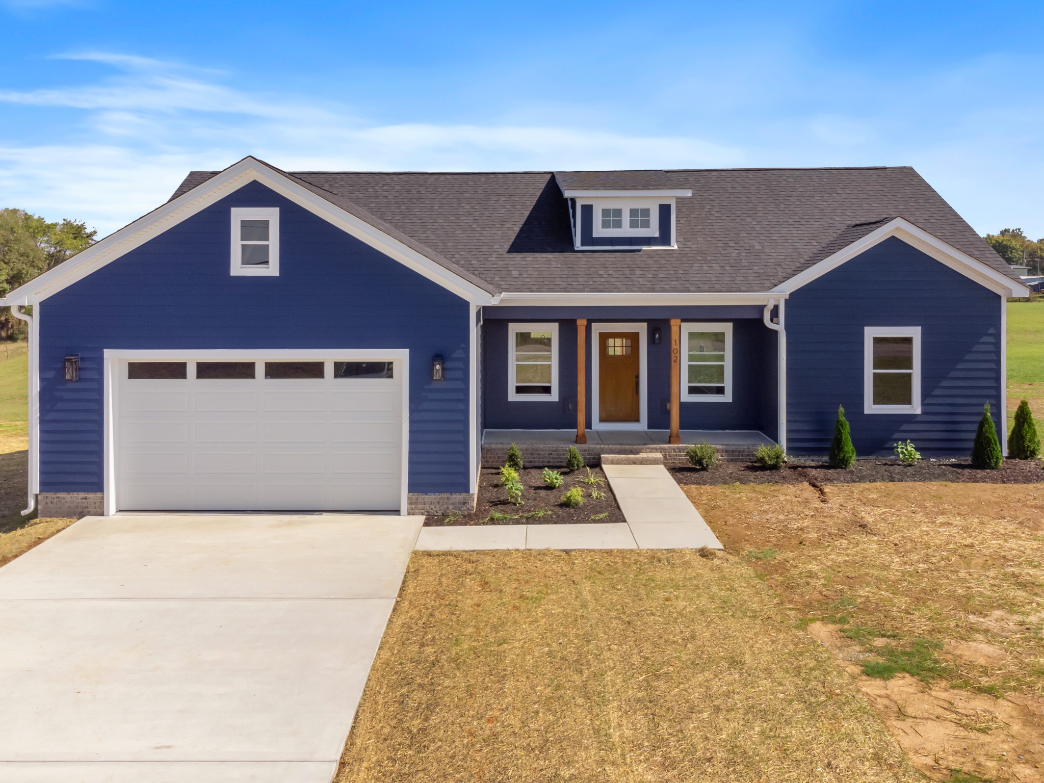 a front view of a house with yard