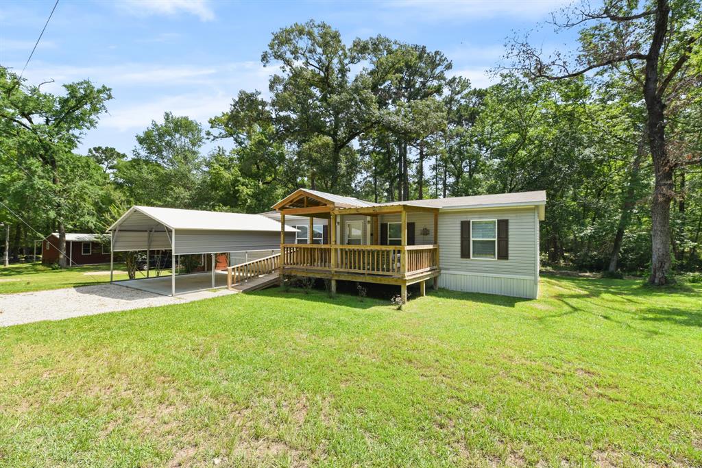 a view of a house with a yard and sitting area