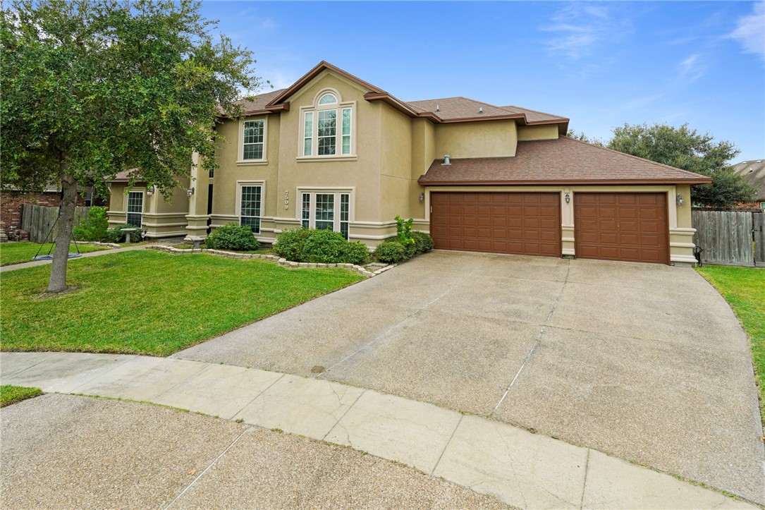 a front view of a house with a yard and garage