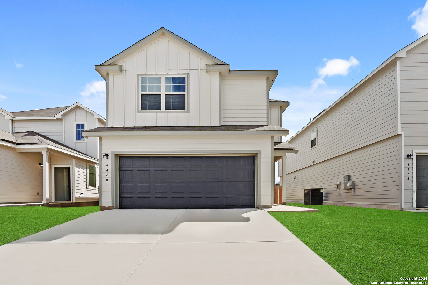 a front view of a house with a yard and garage