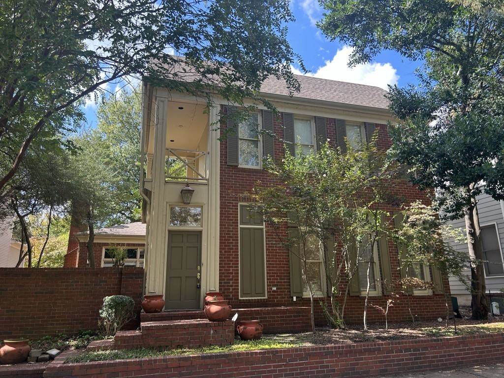 a front view of house with yard space and trees around