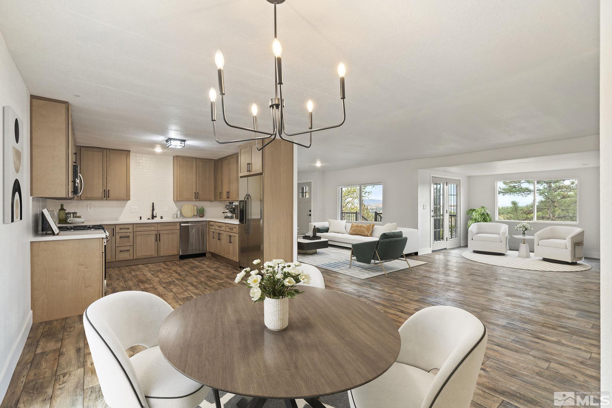 a living room with furniture kitchen view and a wooden floor