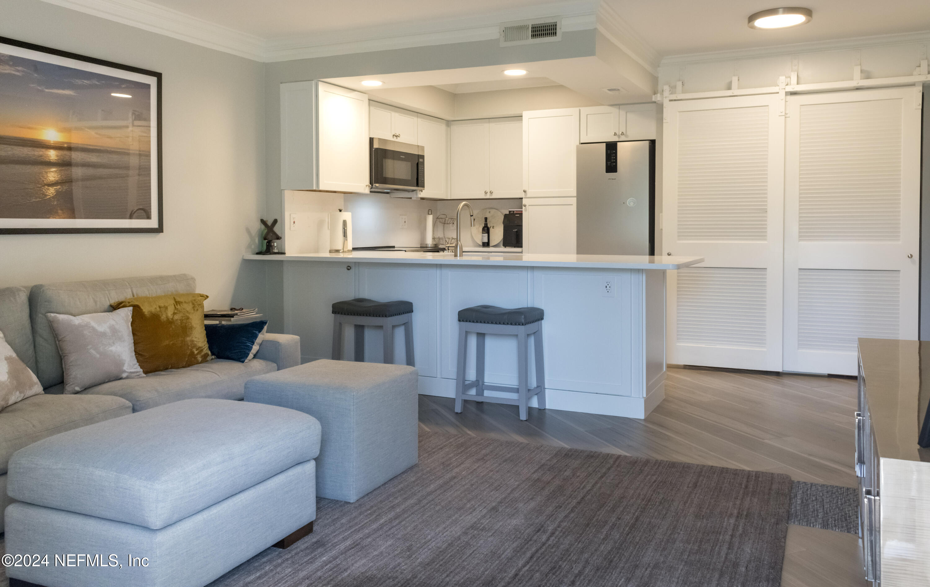 a living room with a couch and a refrigerator