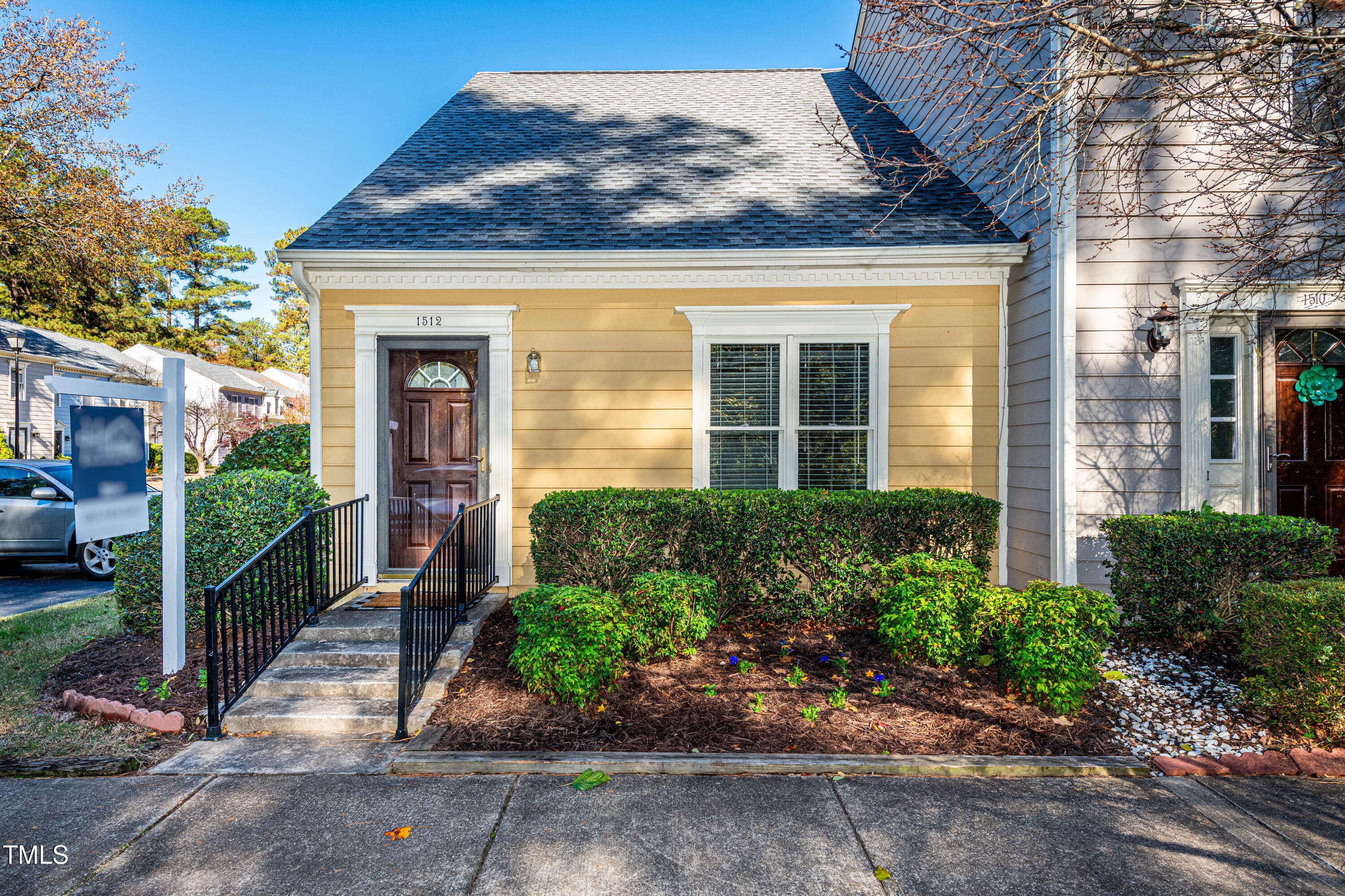 a front view of a house with a garden