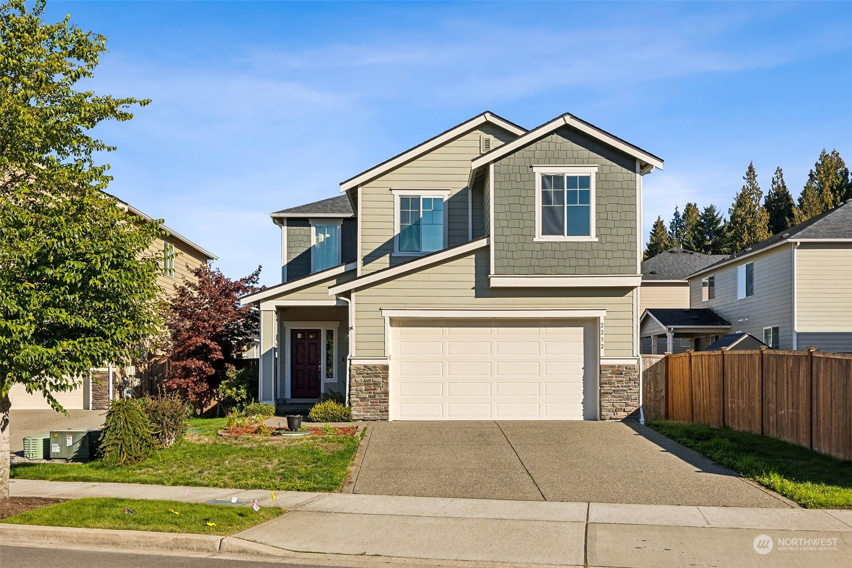 a view of a house with a yard and garage