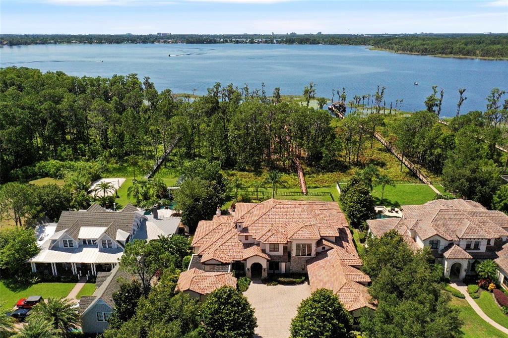 an aerial view of a house with garden space and lake view