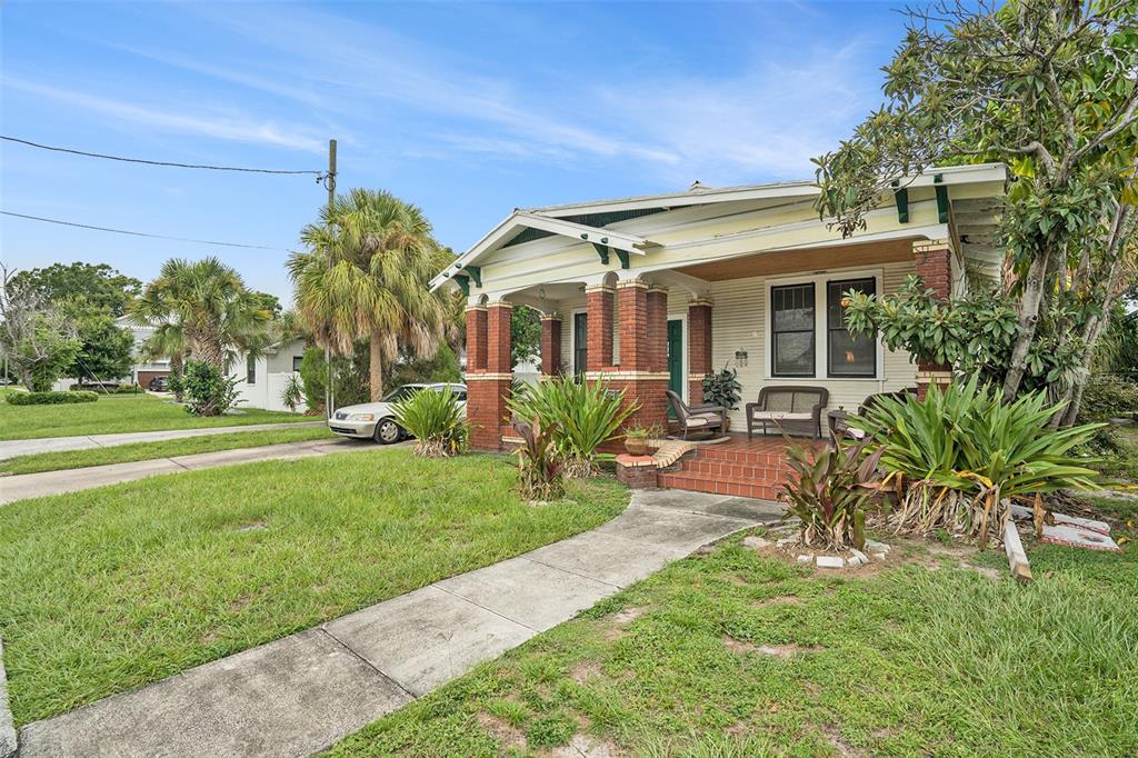 a front view of house with yard and outdoor seating