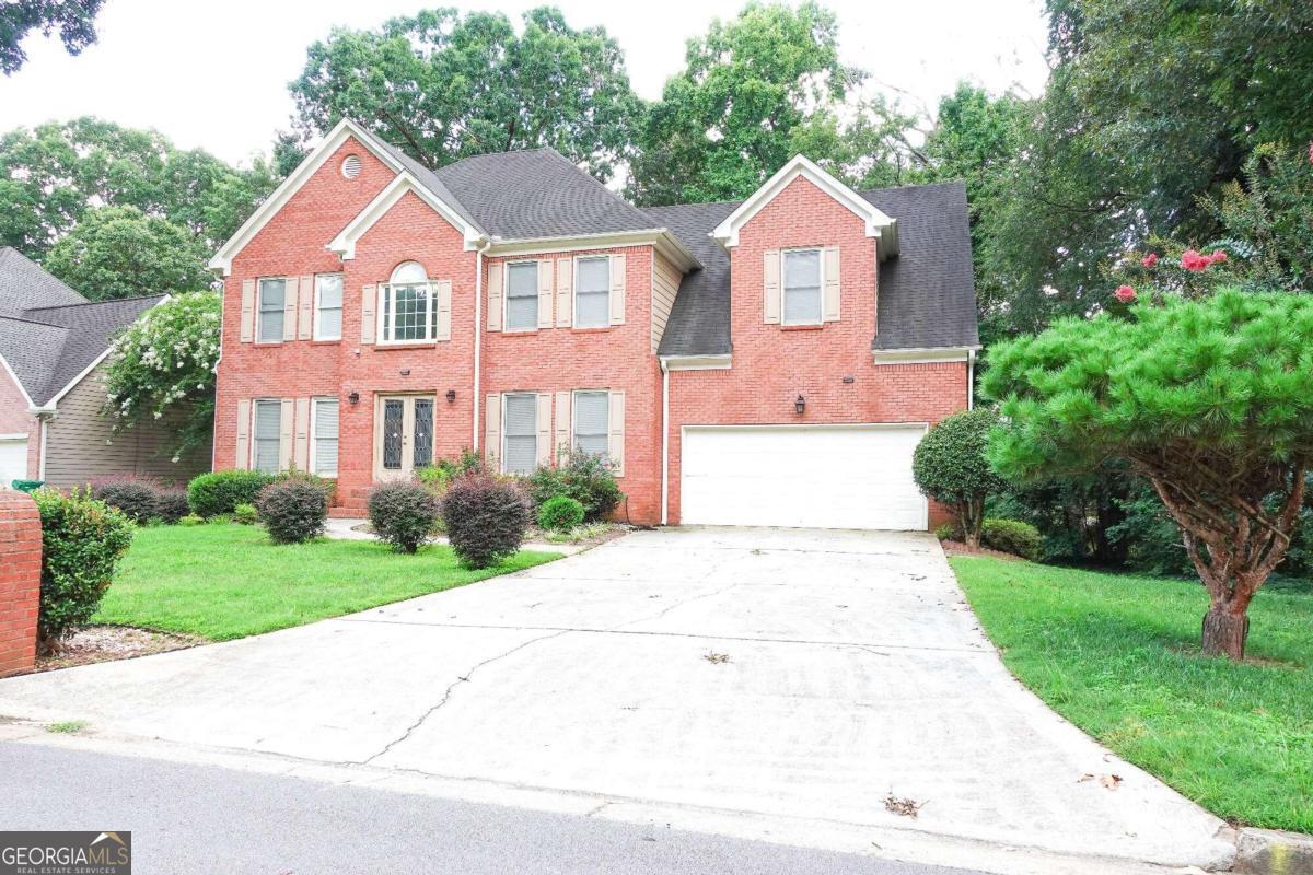 a front view of a house with yard