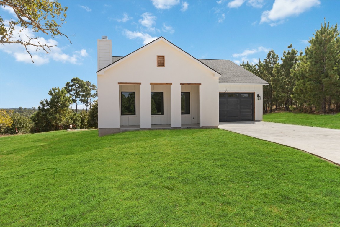 a front view of house with yard and green space