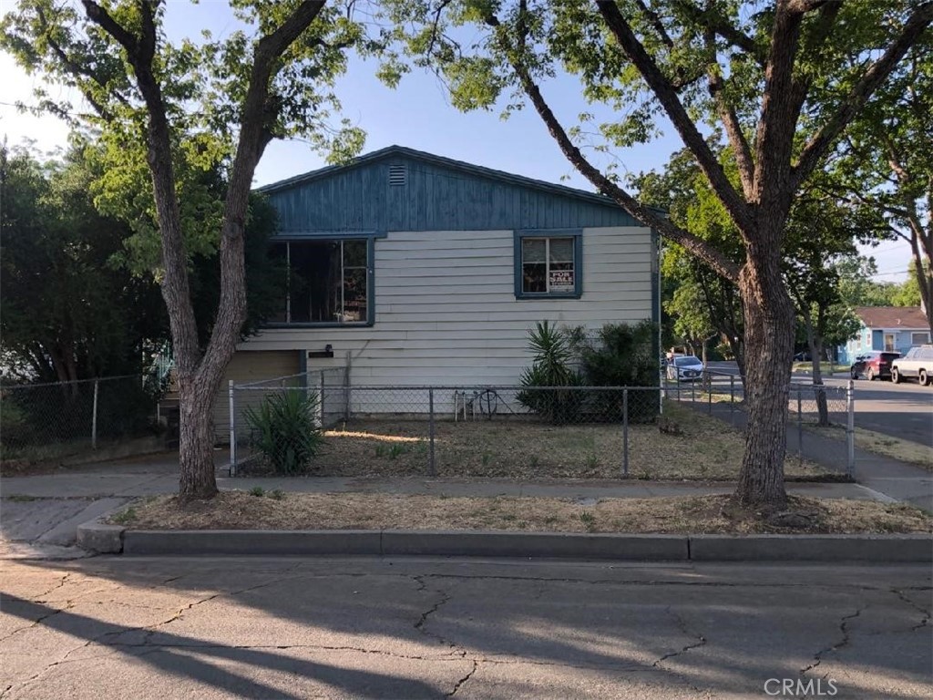 a house that has a tree in front of it