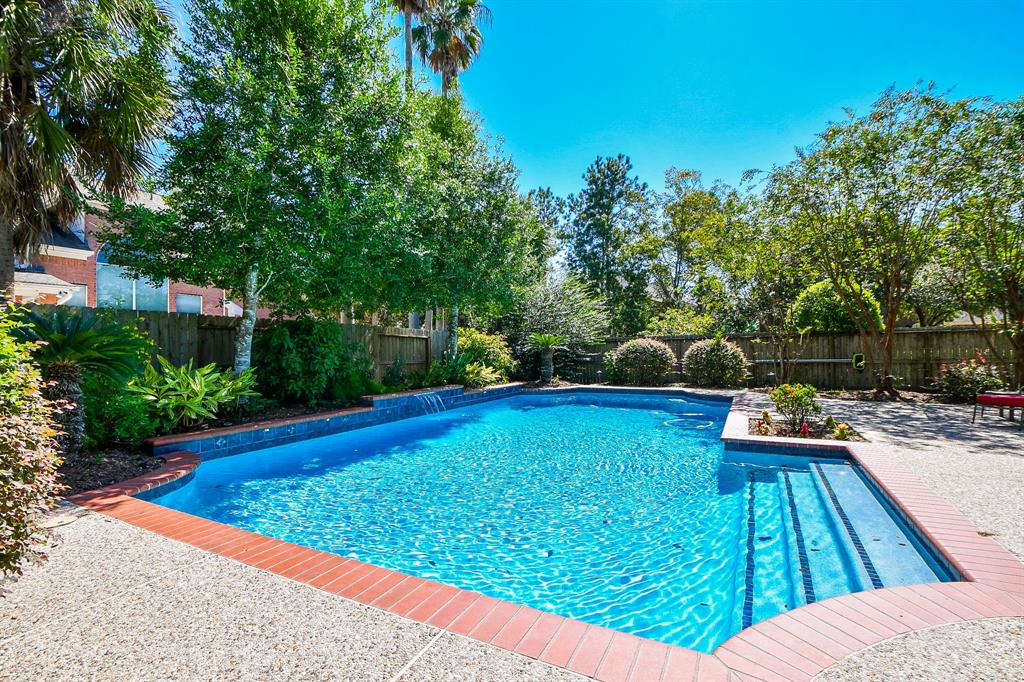 swimming pool view with a seating space