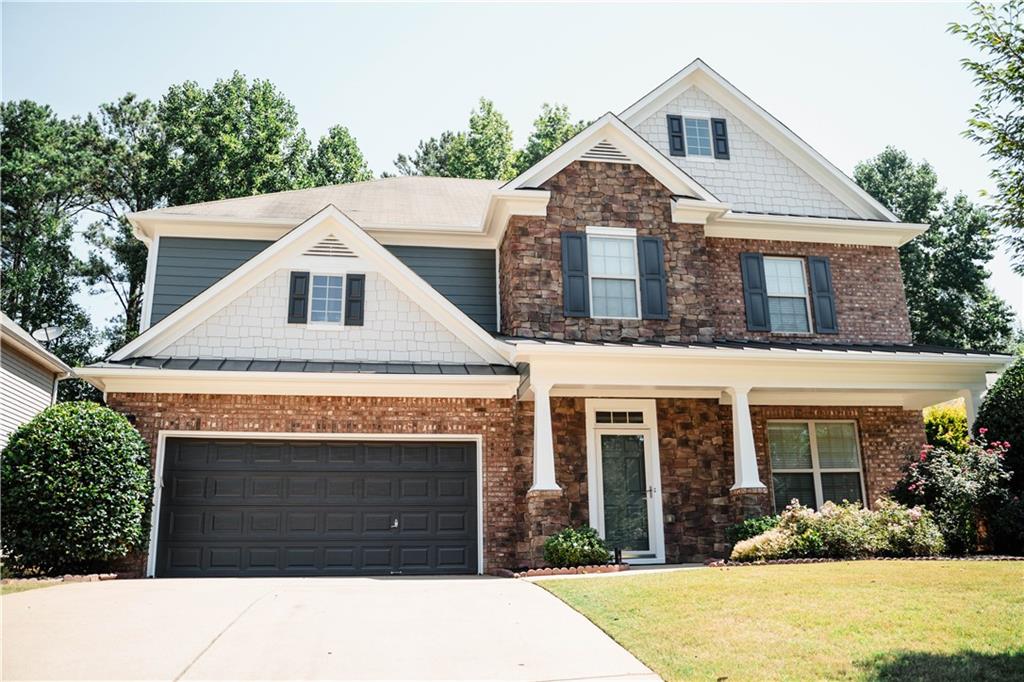 a front view of a house with a yard and garage