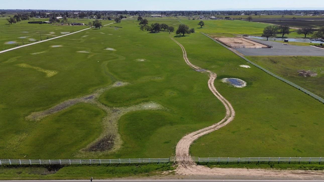 an aerial view of a golf course with a lake view