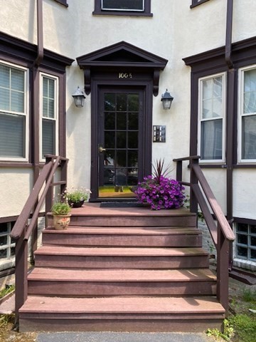 a front view of a house with entryway and windows