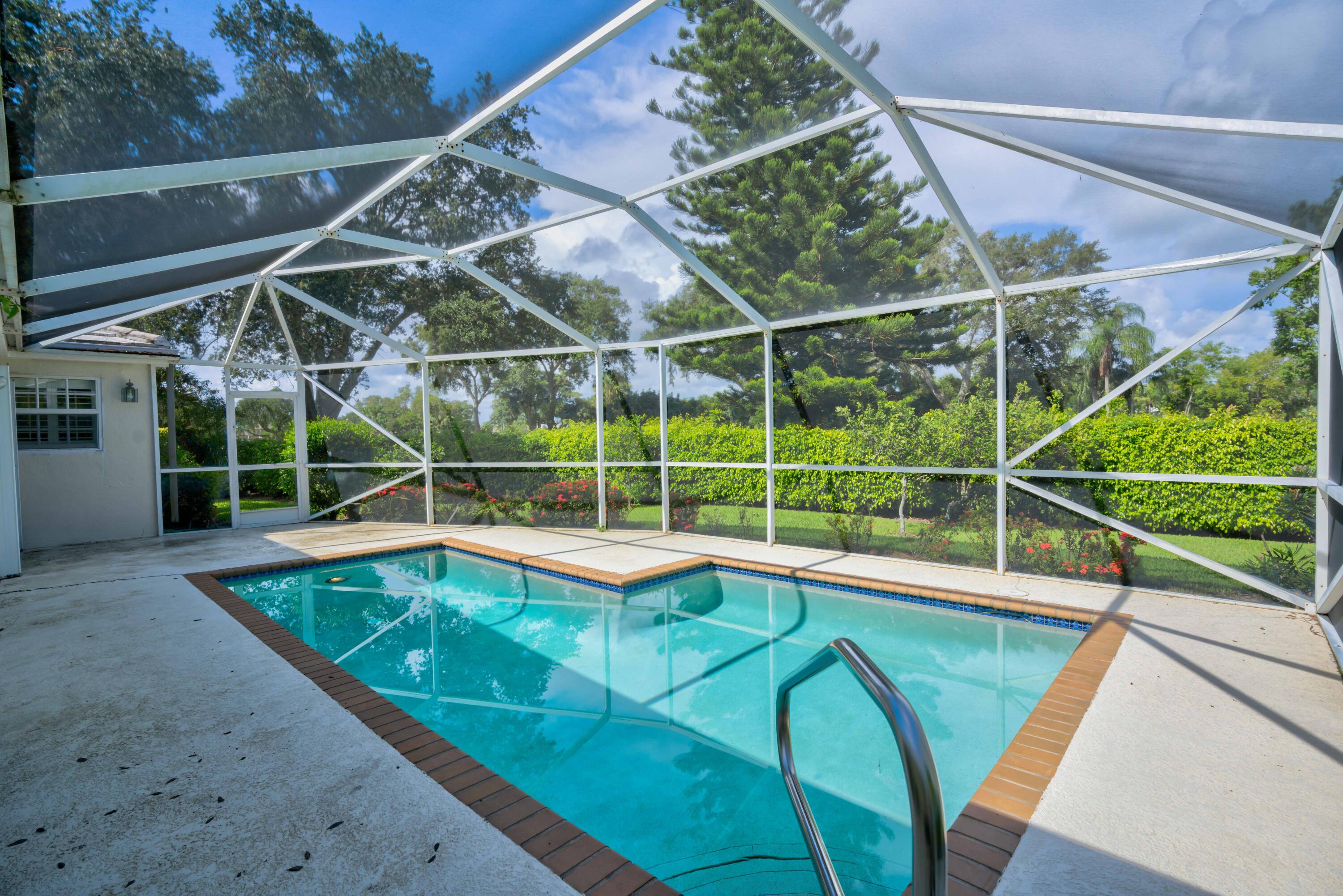 a view of a backyard with swimming pool