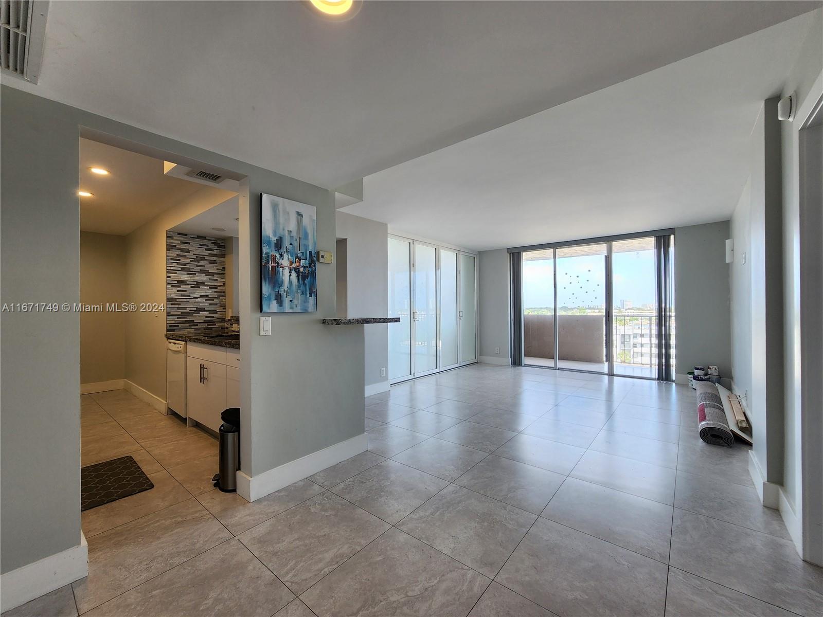 From front door to living room, with the frosted glass doors closed to the CONVERTIBLE room.