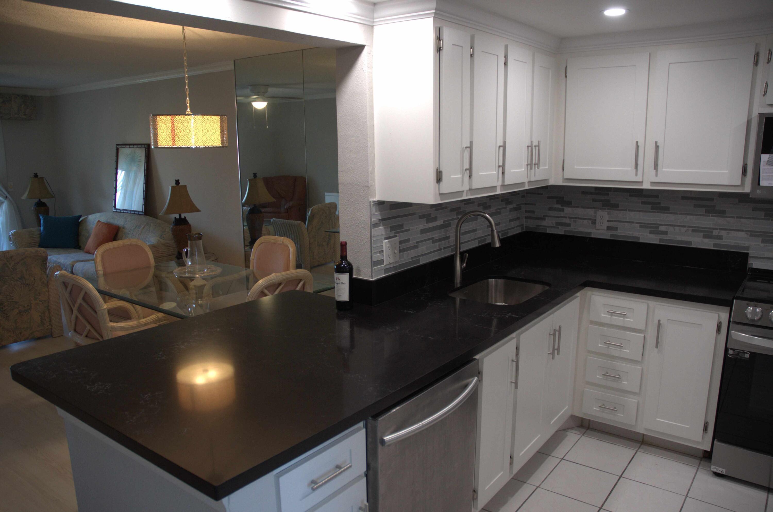 a kitchen with a sink dishwasher and cabinets