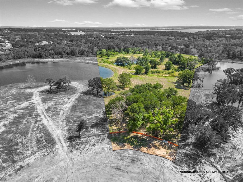 an aerial view of a houses with a lake view