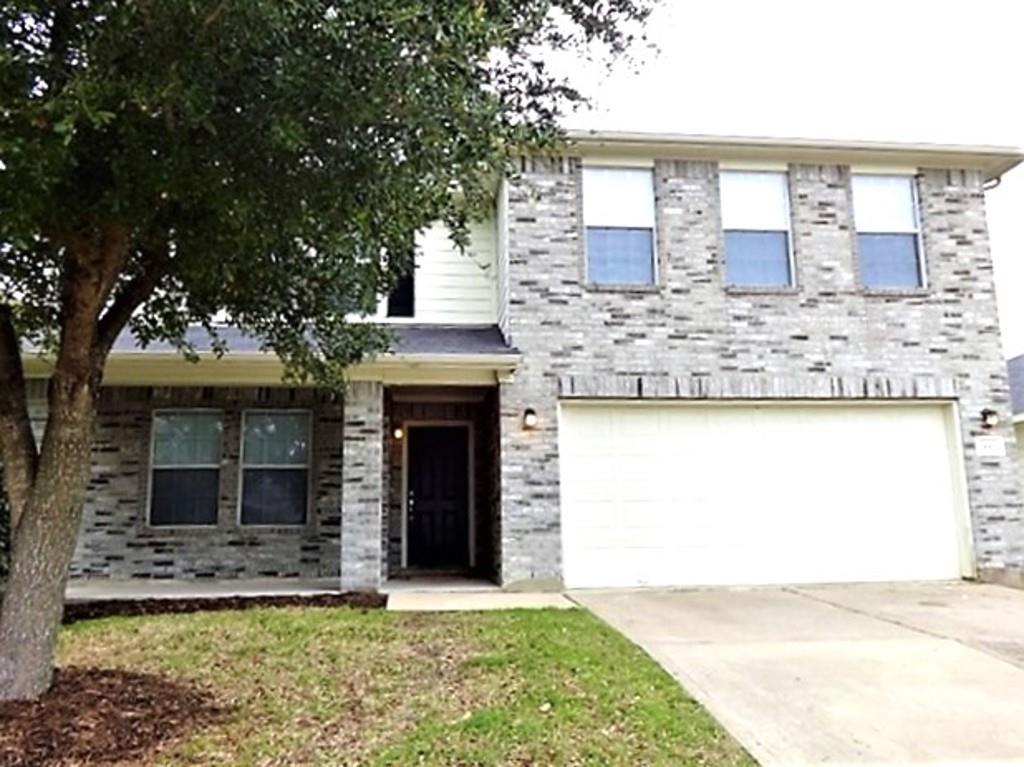 a front view of a house with yard