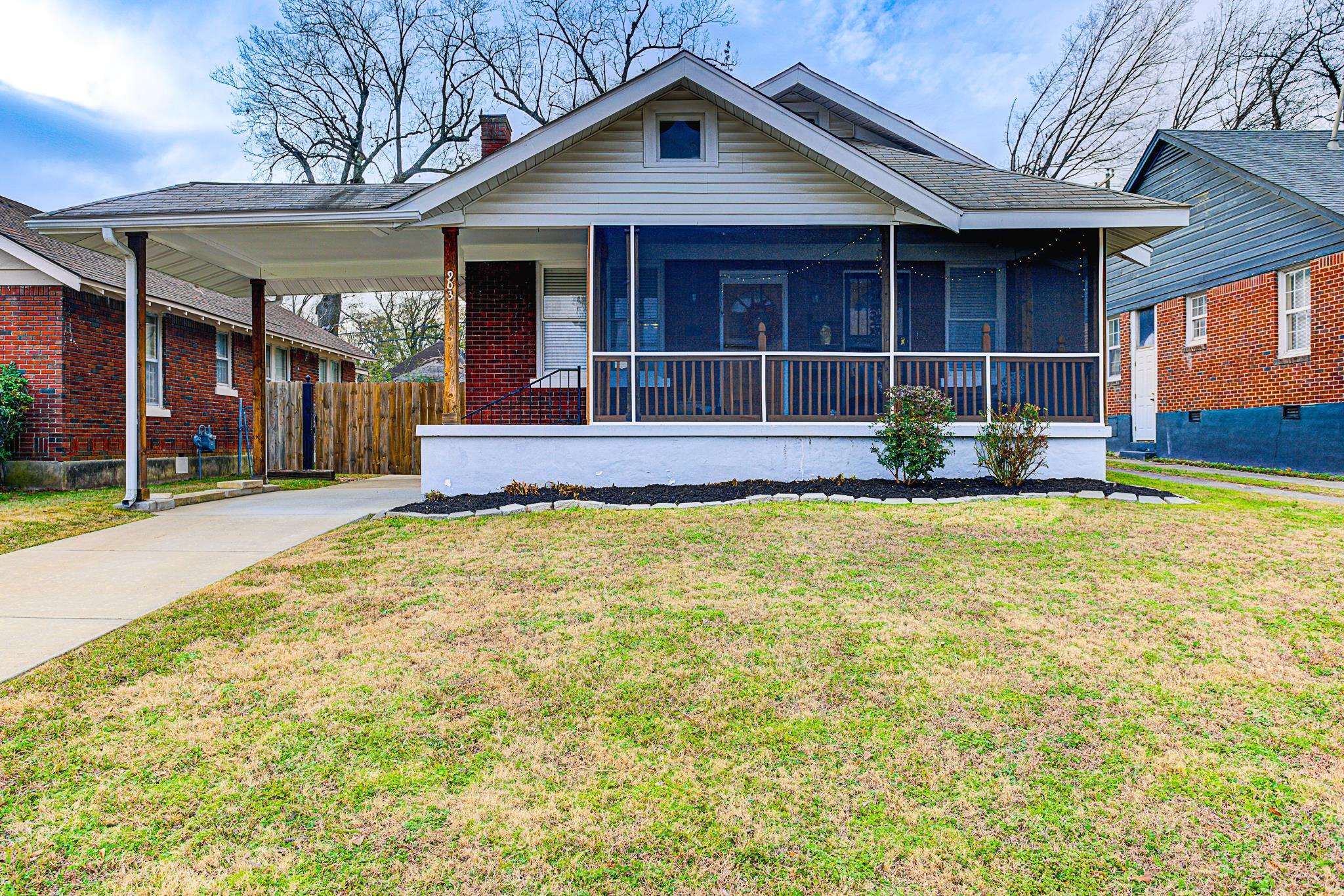 a front view of a house with a yard outdoor seating and garage