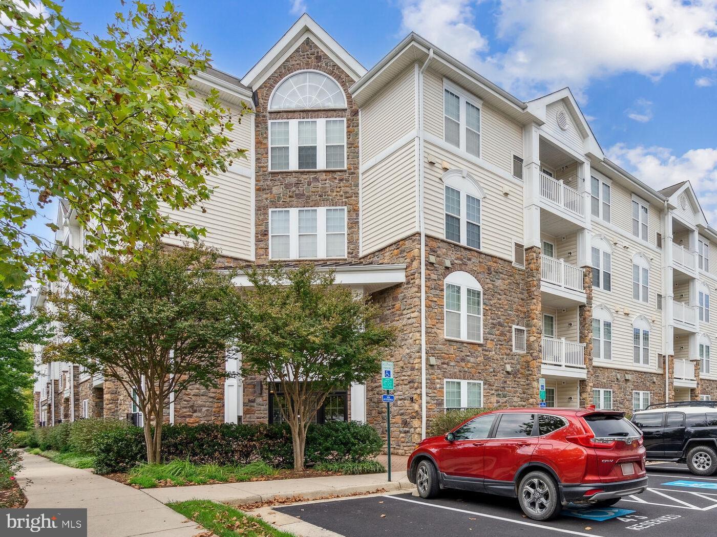 a front view of a residential apartment building with a yard