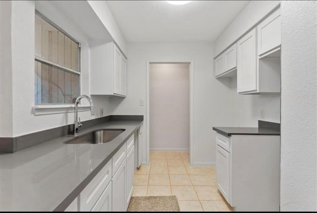 a kitchen with stainless steel appliances granite countertop a sink and a stove