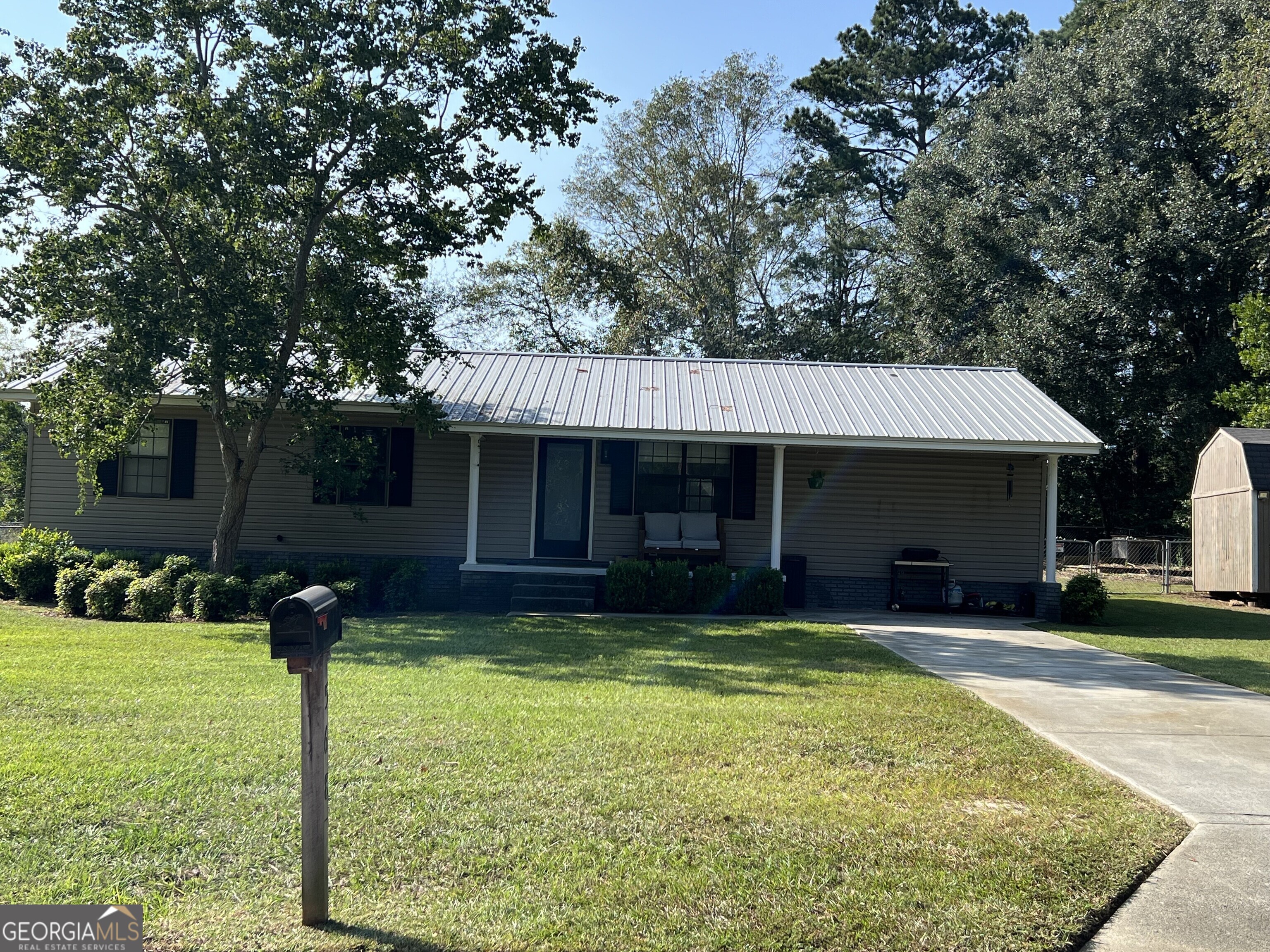 a front view of a house with a yard garage and outdoor seating