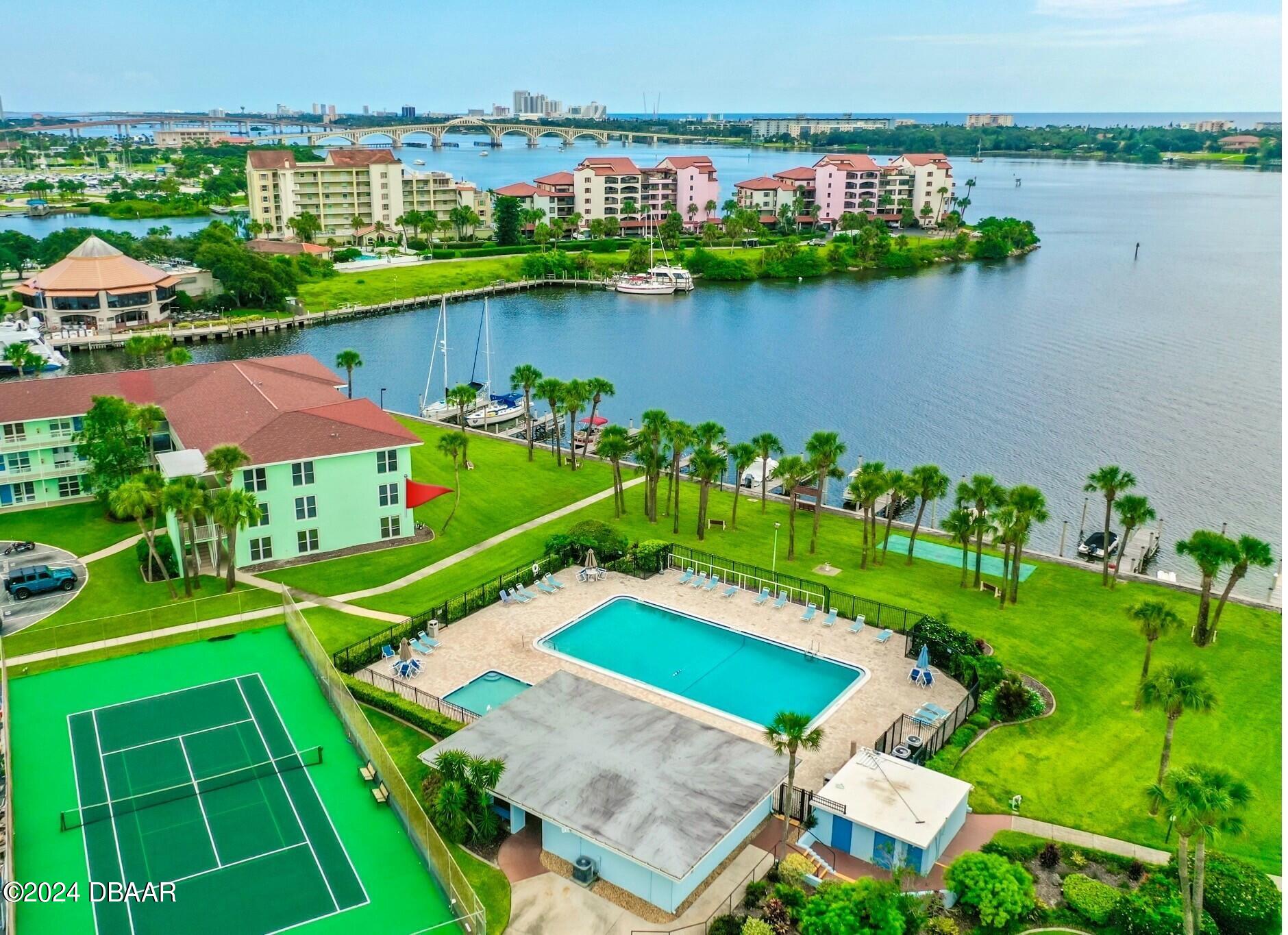 an aerial view of a house with outdoor space swimming pool and lake view