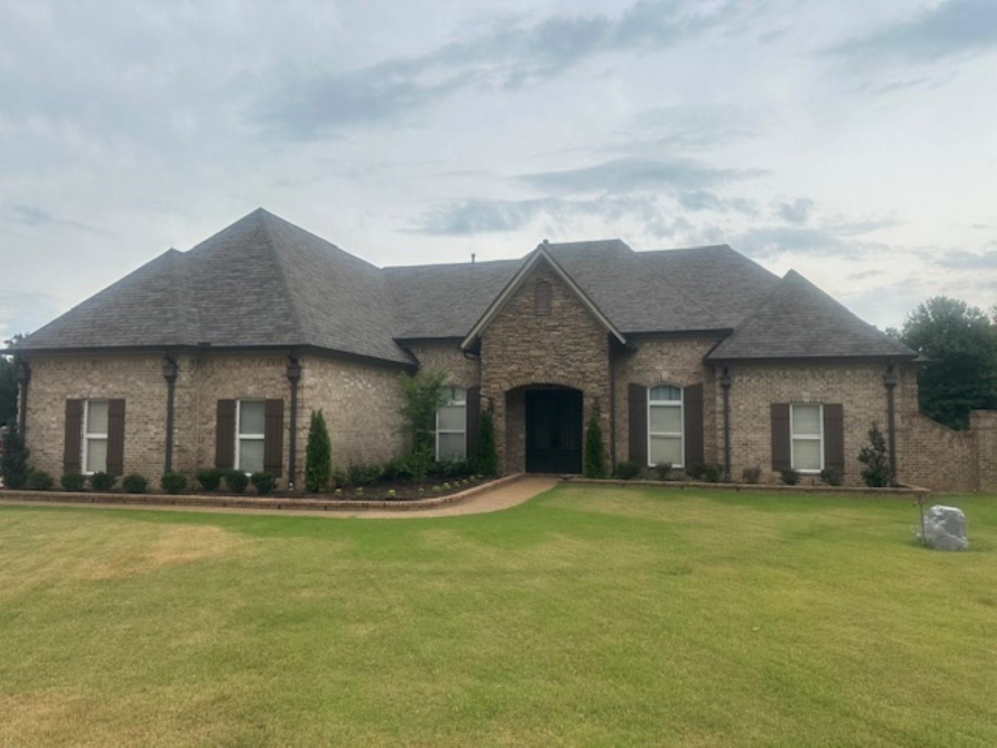 a front view of a house with a yard