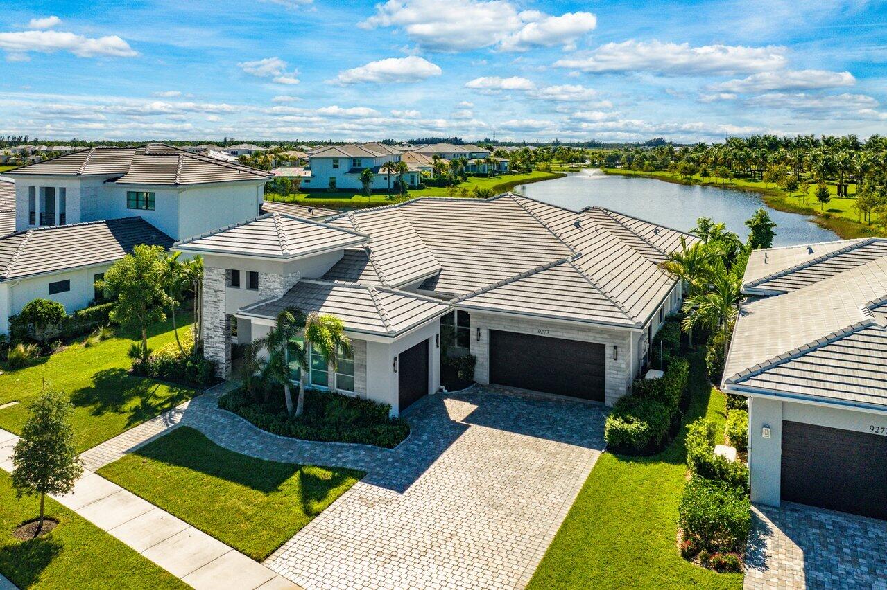 an aerial view of a house with a garden and lake view