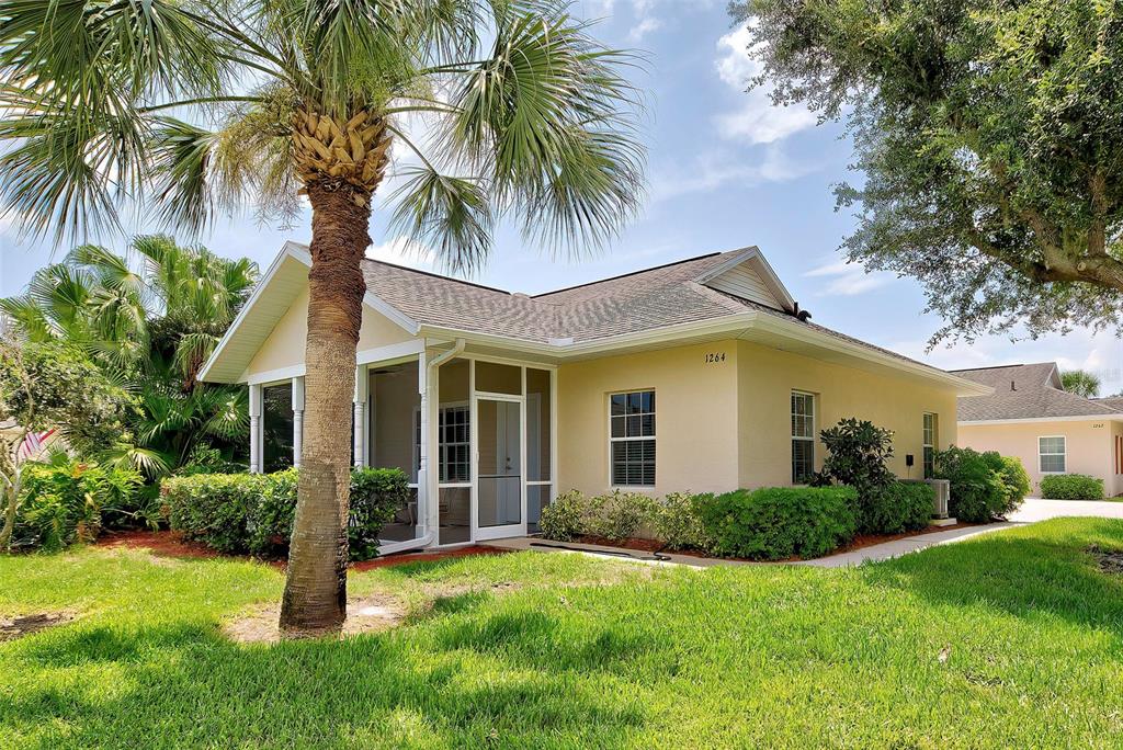 a front view of house with yard and green space