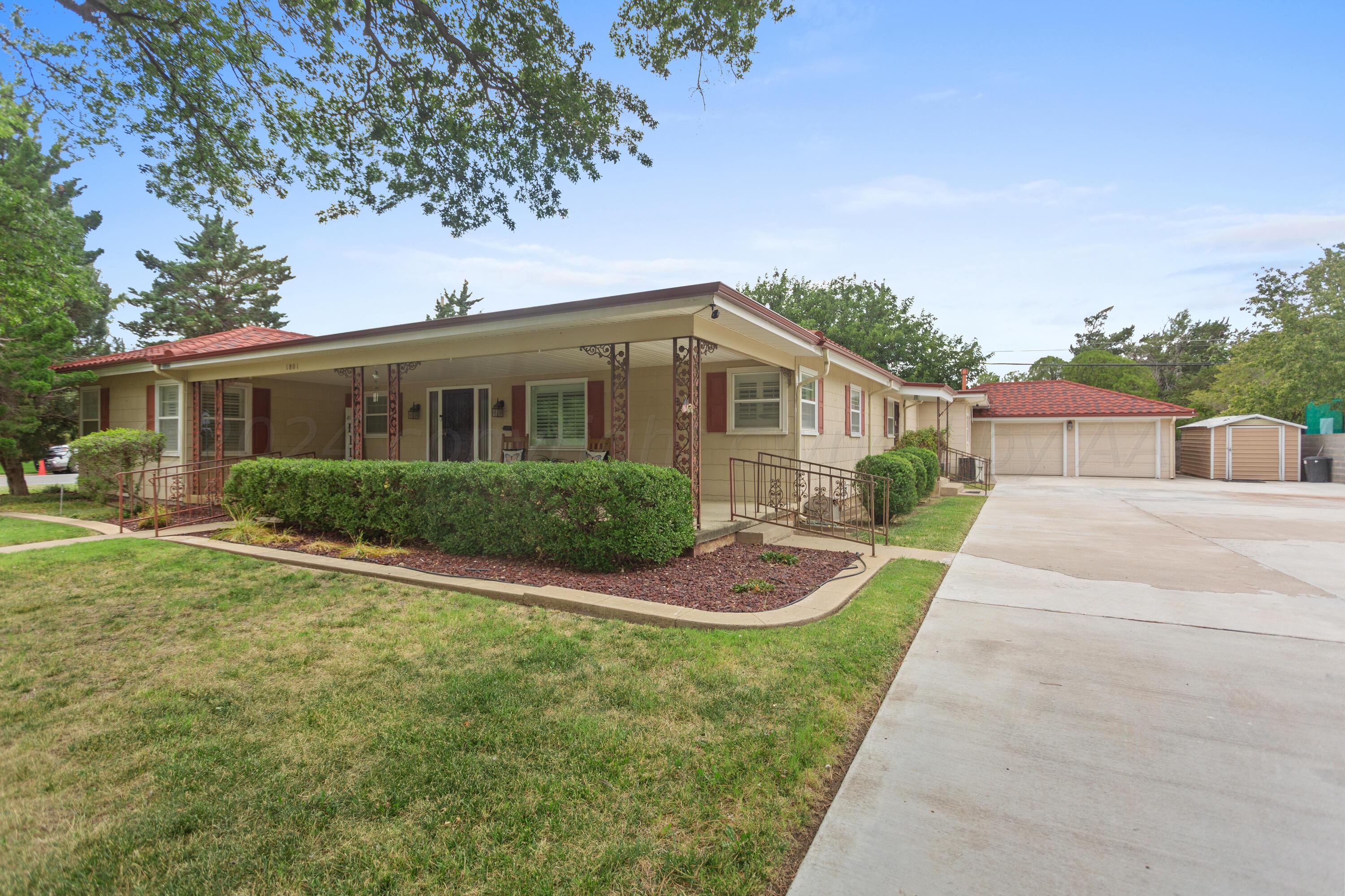 a front view of a house with yard and green space