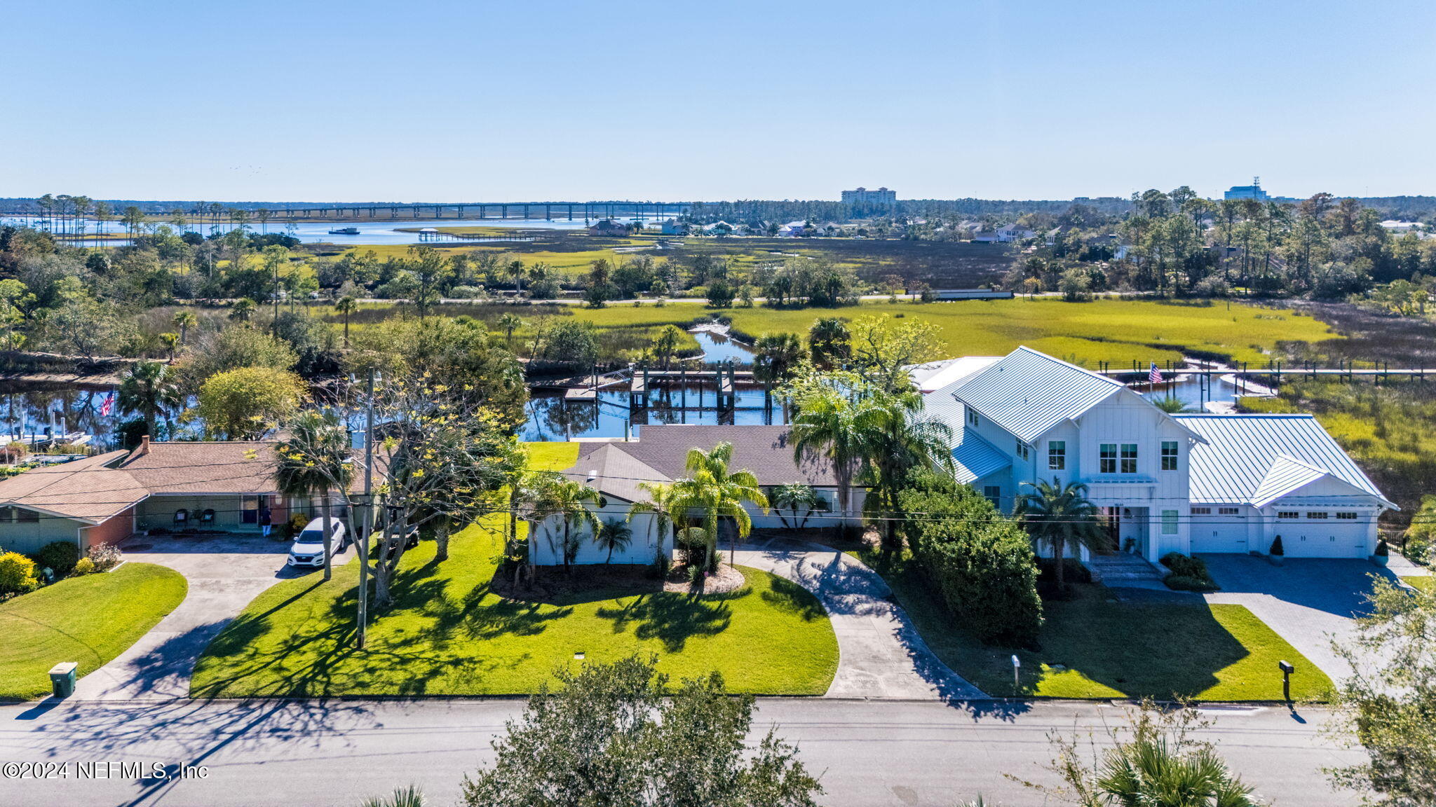 an aerial view of a house with swimming pool and ocean view