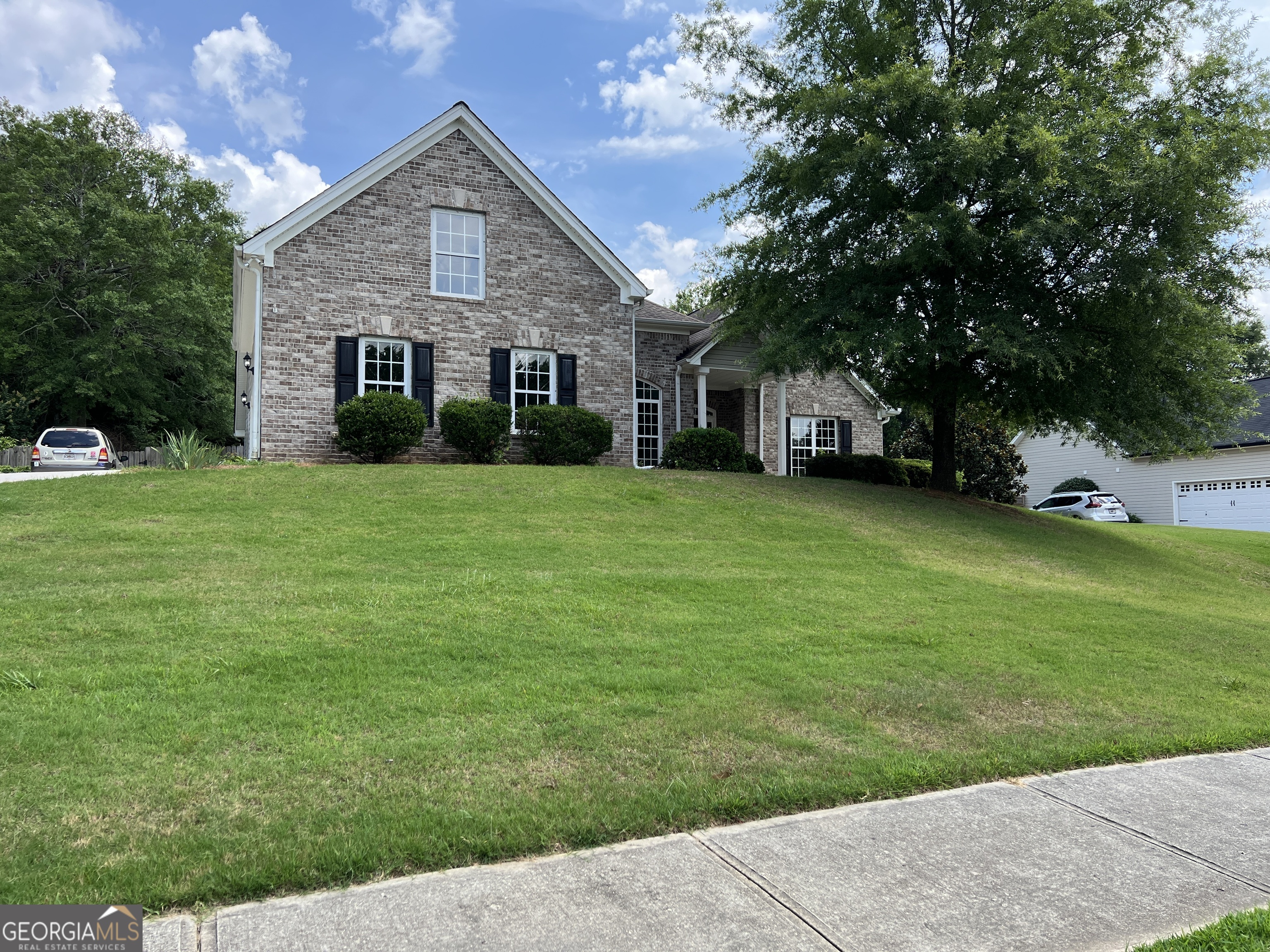 a front view of a house with a garden