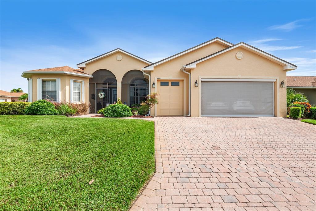 a front view of a house with yard and garage