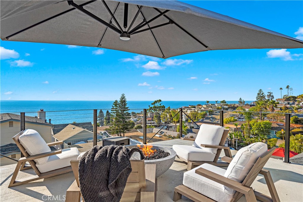 a view of a terrace with furniture and umbrella