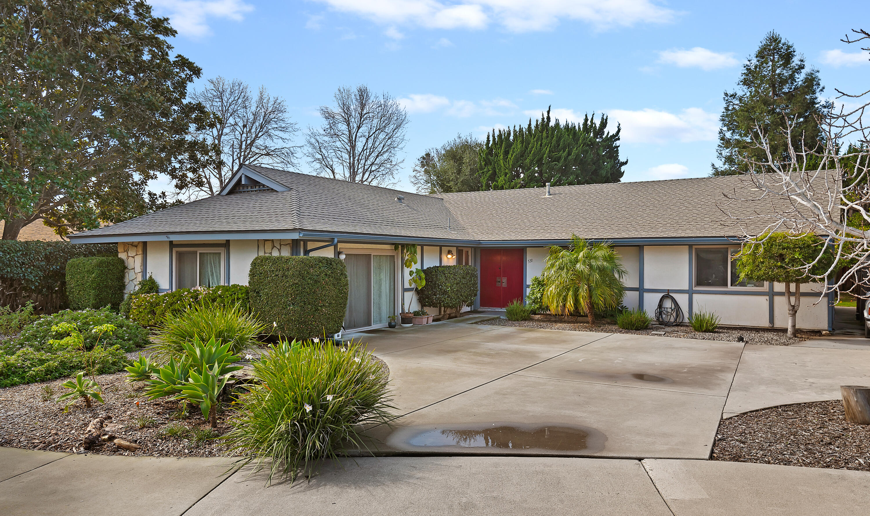 a front view of a house with garden