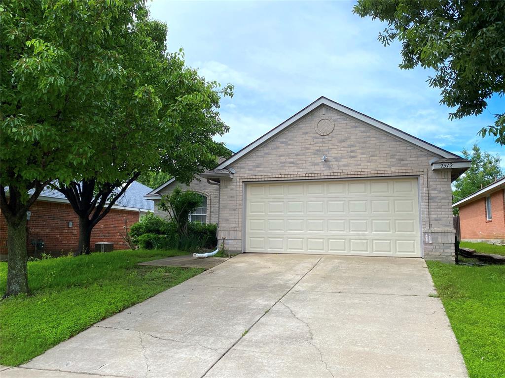 a front view of house with yard and trees