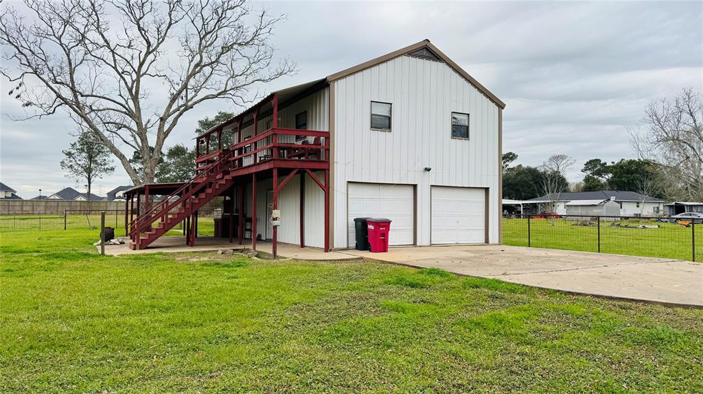 a view of a house with a yard and sitting area