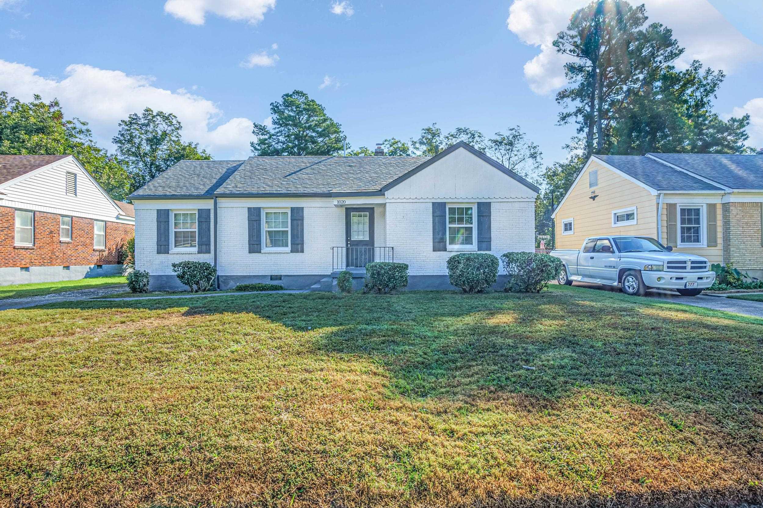 a front view of a house with garden