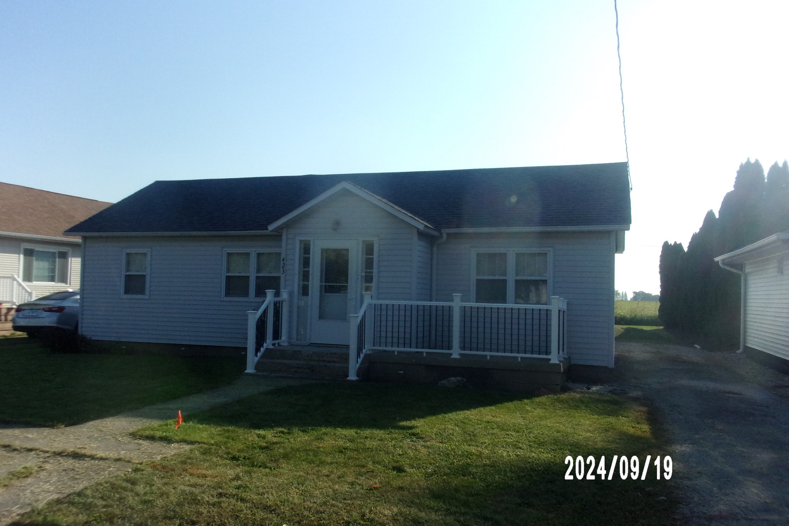 a front view of a house with a garden