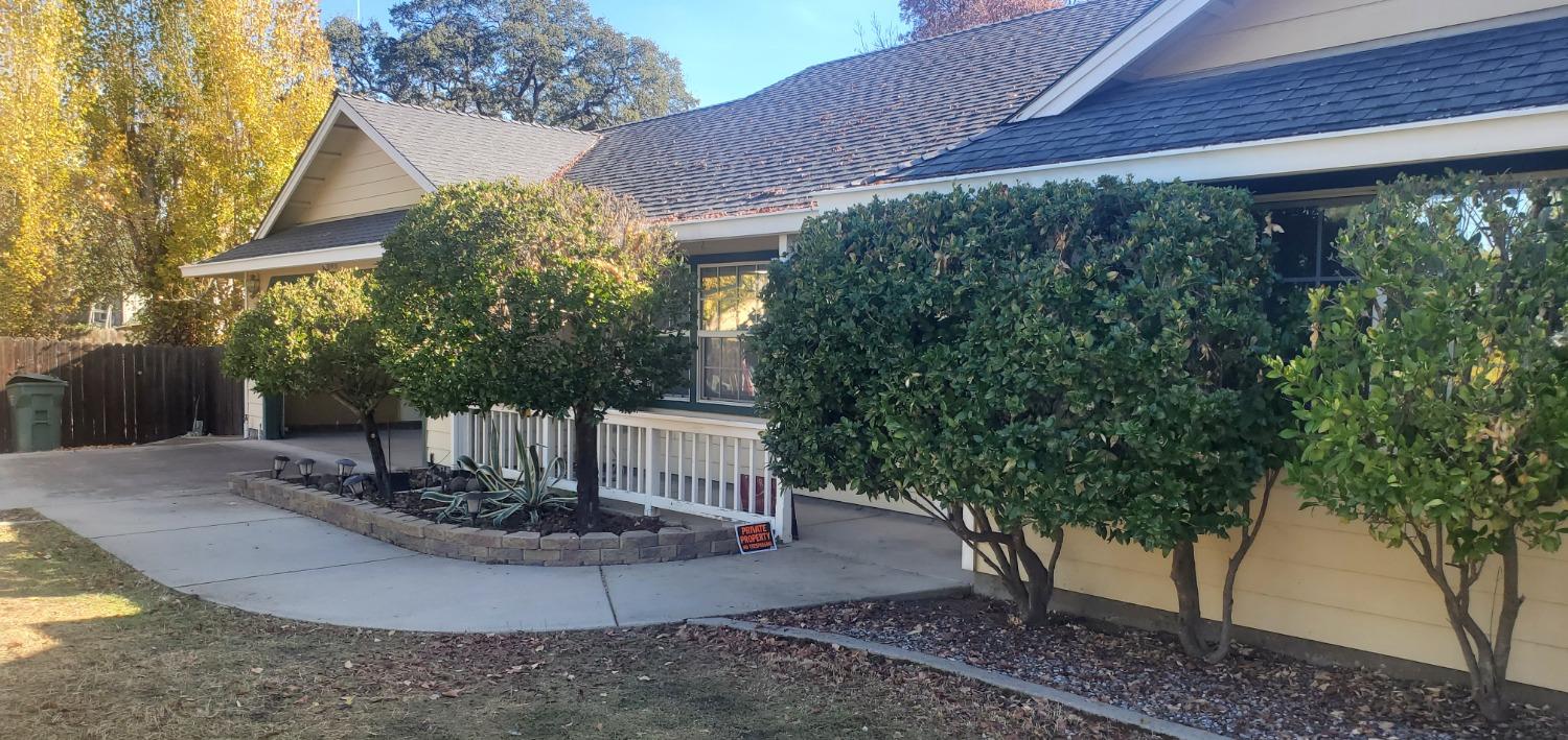 a view of a house with a yard and tree s