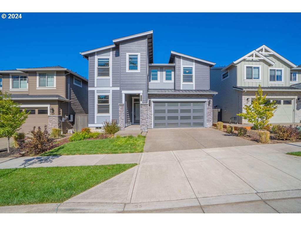 a front view of a house with a yard and outdoor seating