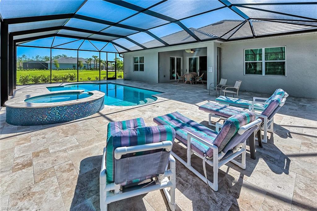 a view of a patio with table and chairs under an umbrella